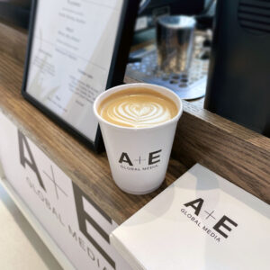 Precision latte printing machine displaying custom corporate company logo on espresso foam